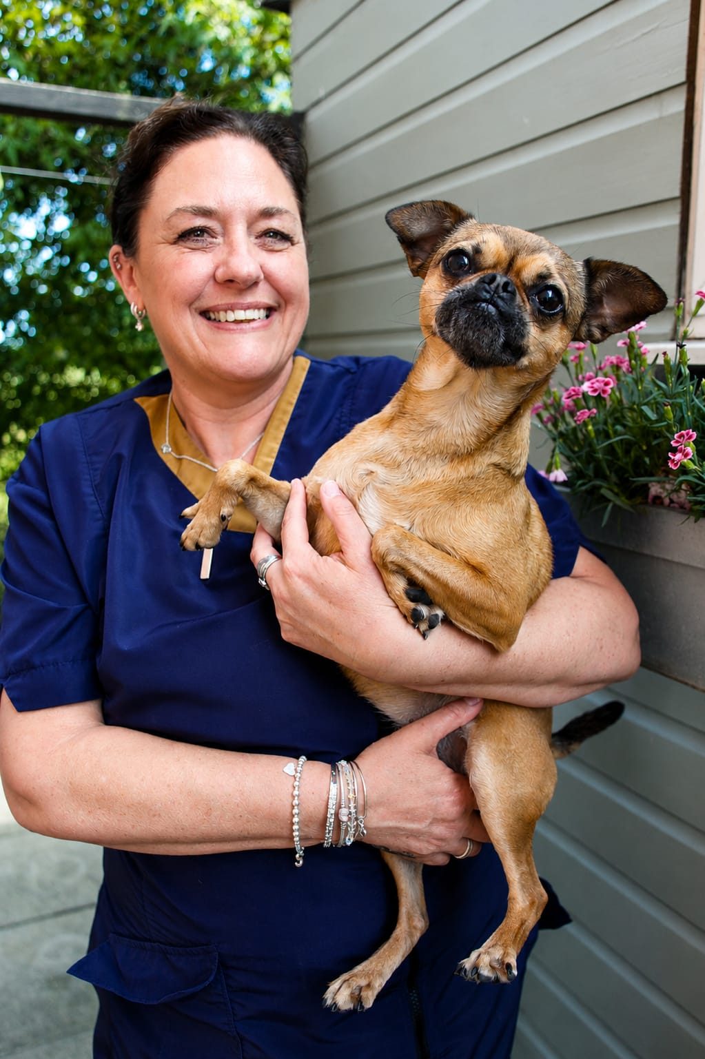 Sally Henwood holding Edith, her Pug cross Chihuahua, outside the studio